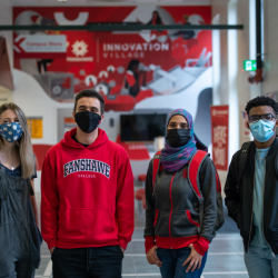 Four masked student standing in a hallway