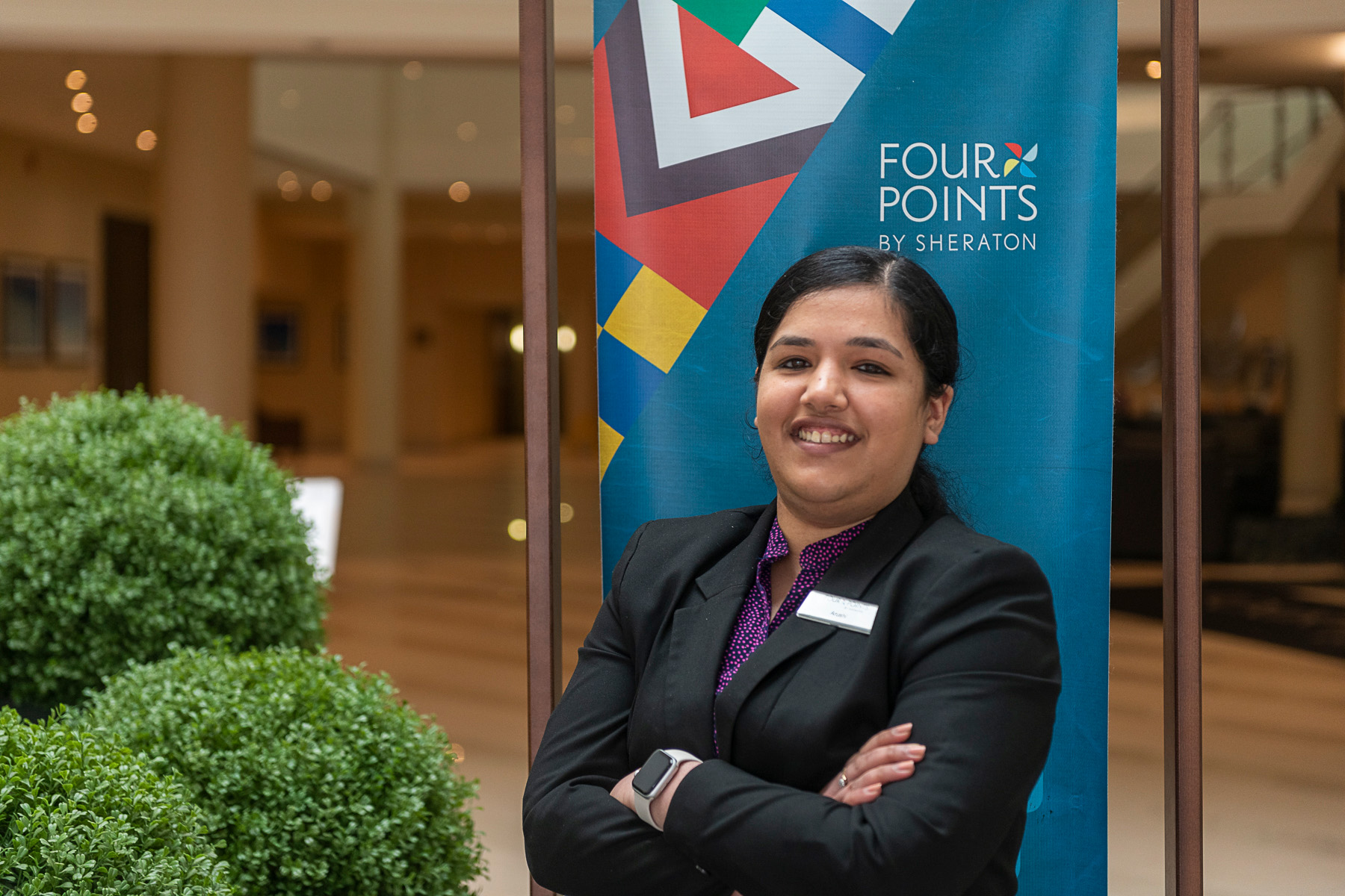 Hospitality employee standing outside out a hotel