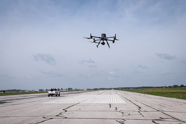 drone lifts off above tarmac