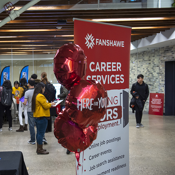 red balloons in front of Fanshawe career fair sign