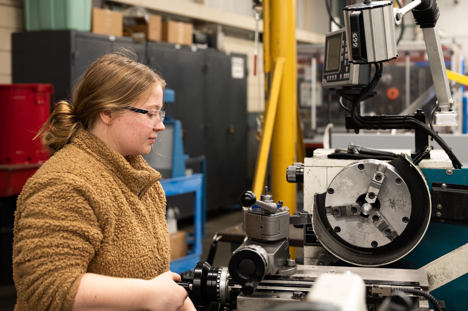 student works on machinery in mechanical engineering technician class