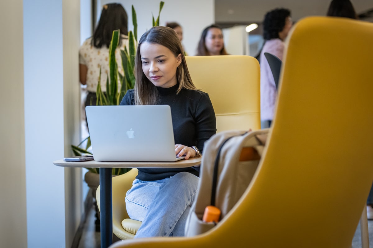 student sits in study space on laptop