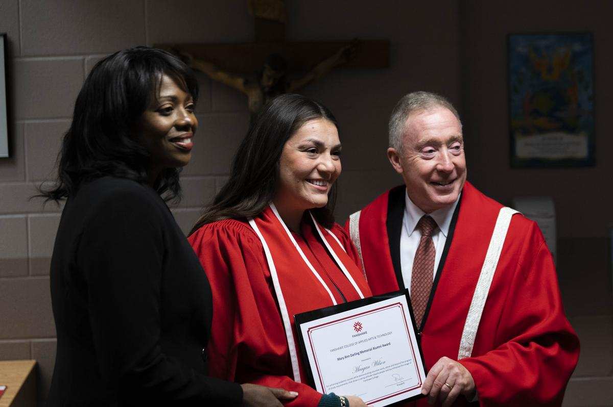 president peter devlin presents award to student