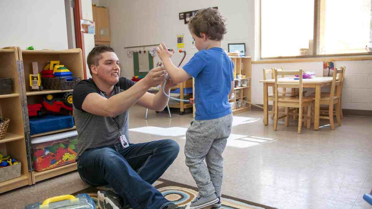 teacher and student play together in classroom