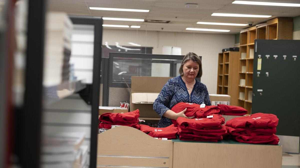 store clerk sorts through product