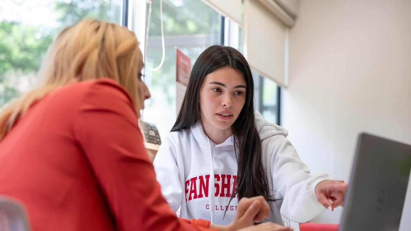 student points at screen while getting support from career services consultant