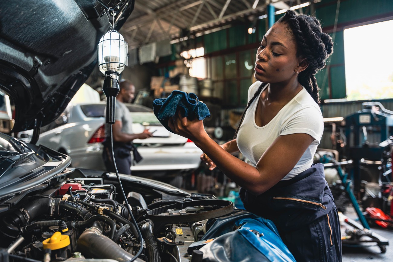 woman works on vehicle repair