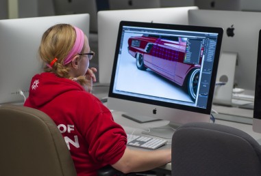 Graphic design student working in computer lab on illustration
