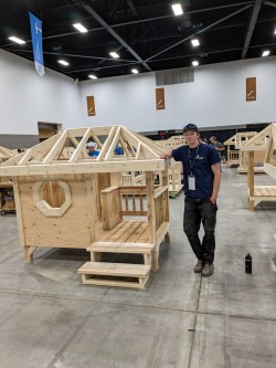A student stands next to his build during the Skills Canada competition.